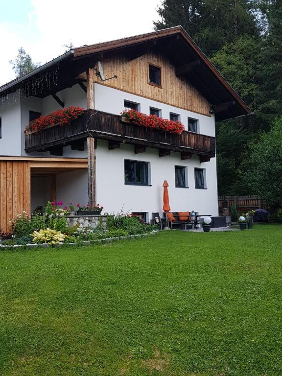 a large white house with a gambrel roof at Ferienhaus Stricker in Ehrwald