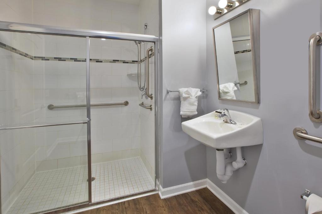 a bathroom with a shower, sink, and tub at Hotel Chicago West Loop in Chicago