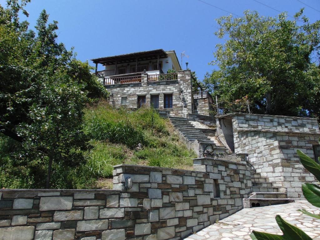 a building on top of a stone retaining wall at Villa Katerina in Tsagarada