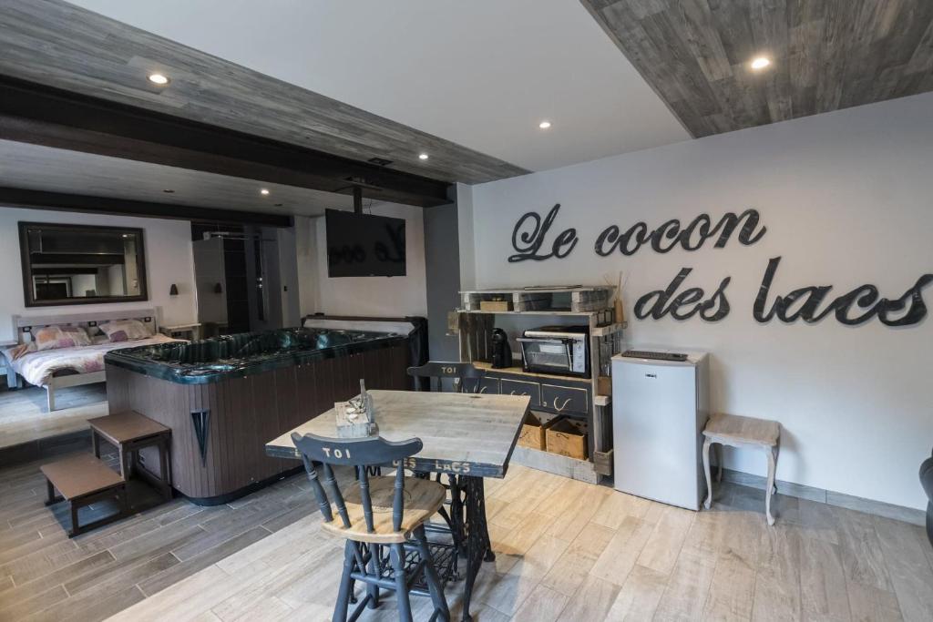 a kitchen with a table and a sign that says do ocean uses taxes at Le cocon des lacs in Boussu-lez-Walcourt