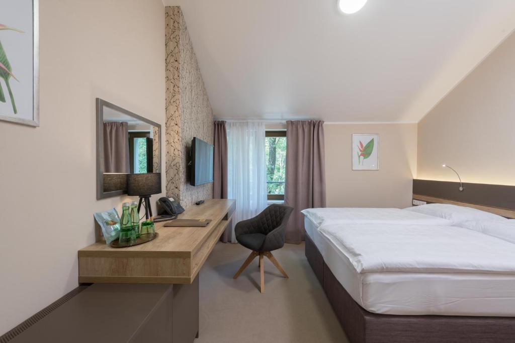 Postel nebo postele na pokoji v ubytování Hotel Panská Zahrada