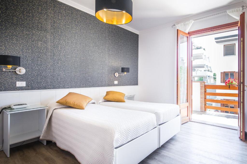 Postel nebo postele na pokoji v ubytování Hotel Capanna d'Oro