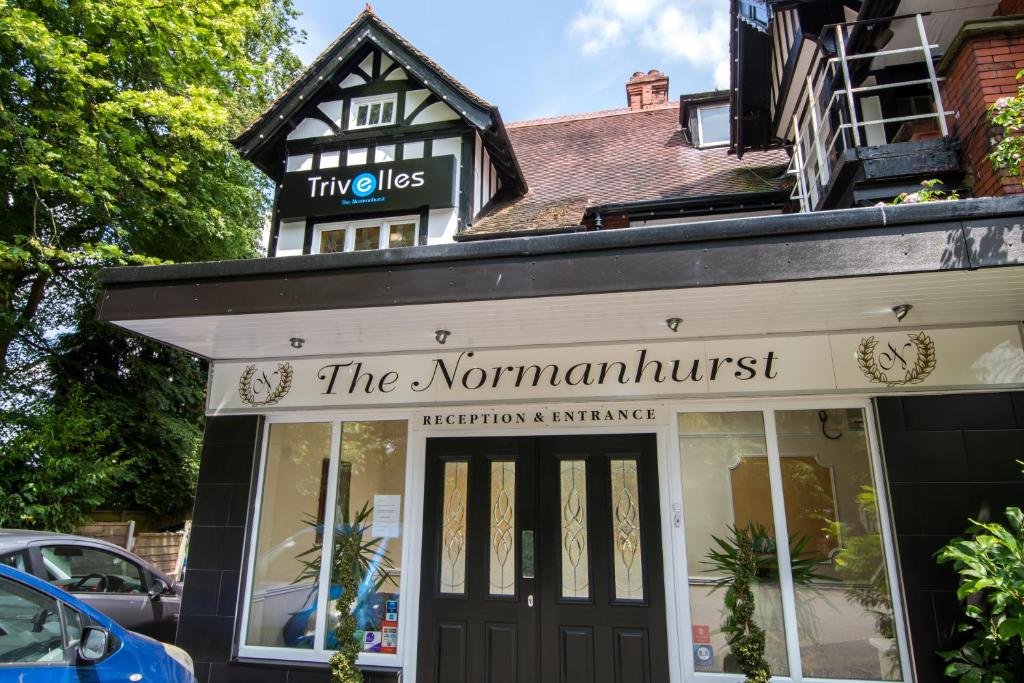 a shop with a sign that reads the nominators at NormanHurst Hotel in Sale