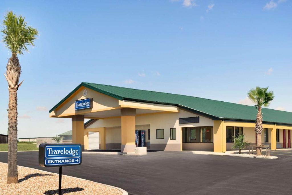 a hotel with a sign in front of a building at Travelodge by Wyndham Unadilla - Perry Near I-75 in Unadilla