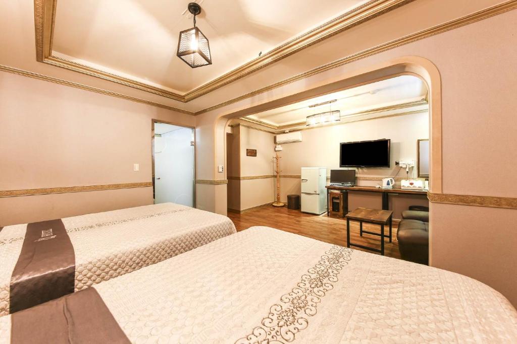 Postel nebo postele na pokoji v ubytování Q Hotel Yongin