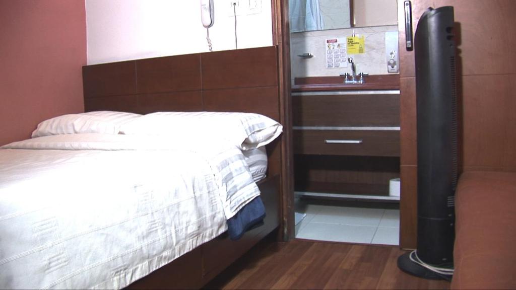 Postel nebo postele na pokoji v ubytování Hotel Apartasuite Normandia