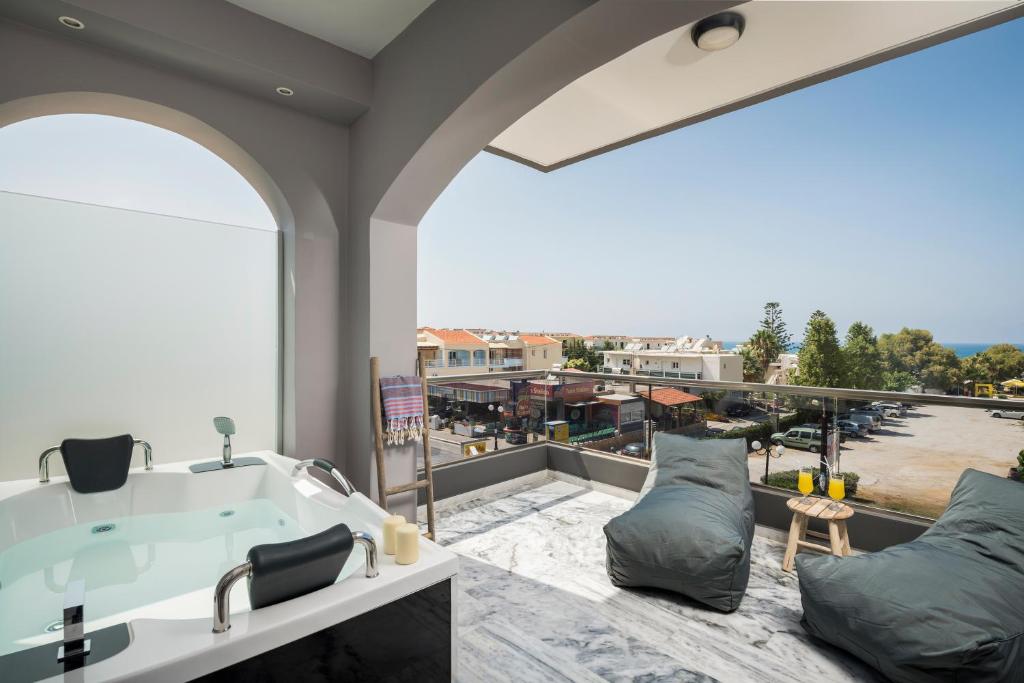 a bathroom with a bath tub and a large window at Sun Ray Luxury Apartments in Agia Marina Nea Kydonias