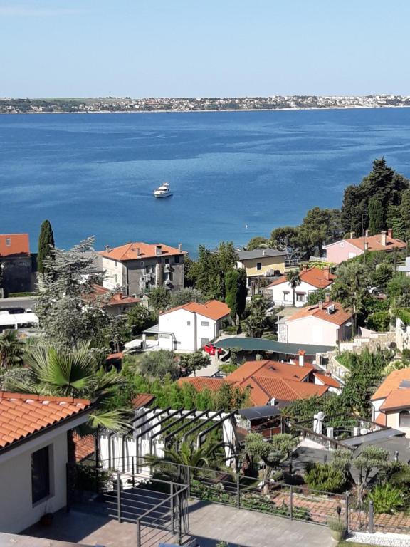 a view of a town with a boat in the water at Apartma Ursa in Portorož