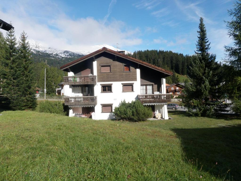 a large house with balconies on a green field at Parc Anemona (274 Ba) in Lenzerheide
