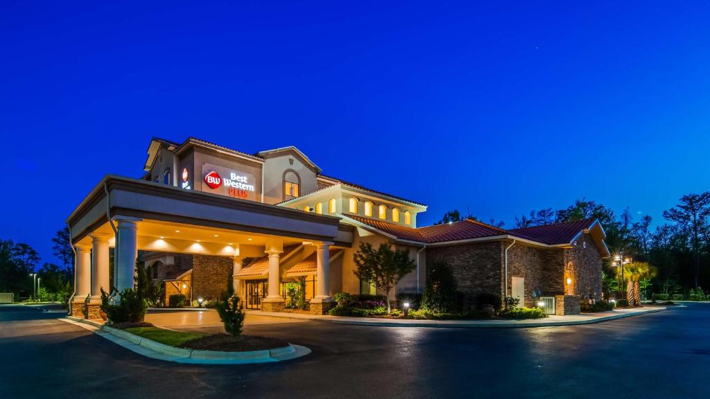 a rendering of the front of a hotel at night at Best Western PLUS Westgate Inn and Suites in Leland