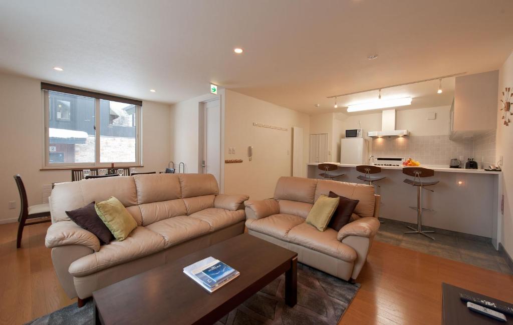 a living room with a couch and a table at Nichigo in Kutchan