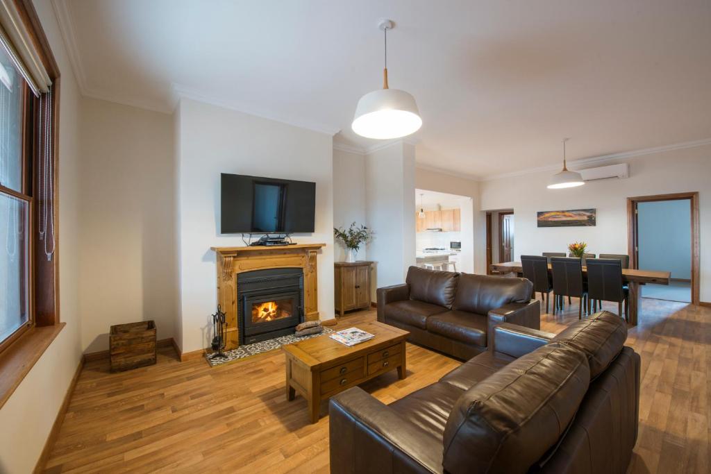 a living room with a couch and a fireplace at Flinders Bush Retreats in Hawker