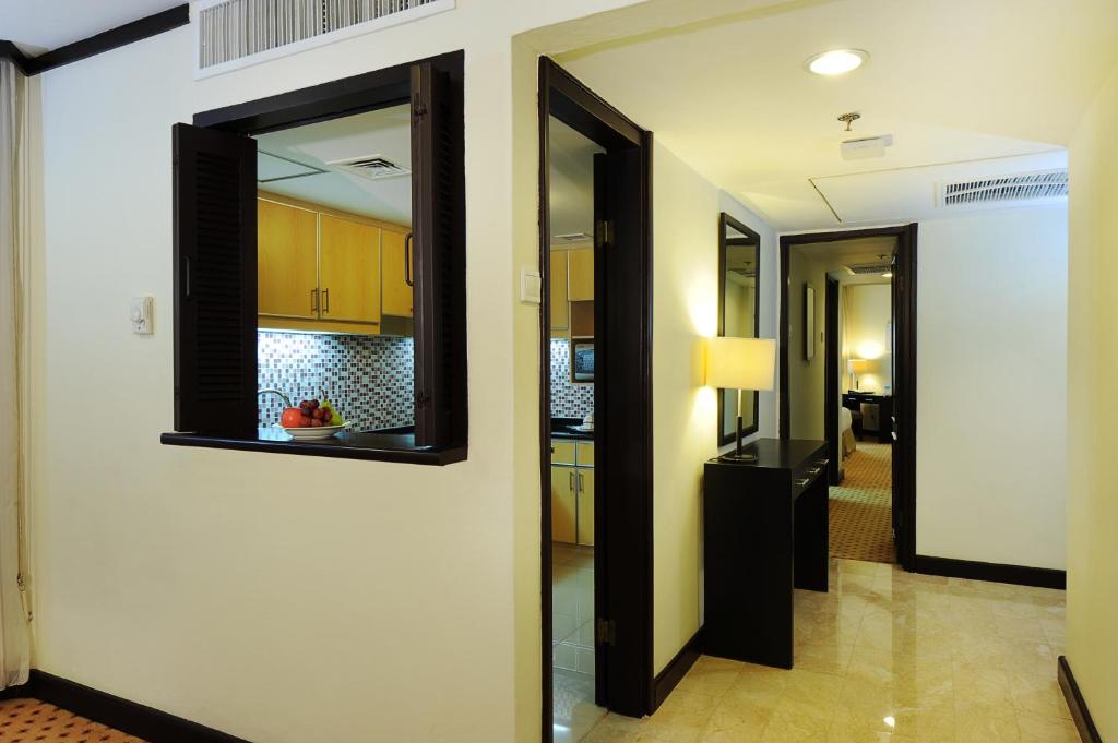 a hallway with two mirrors and a kitchen at Hotel Borobudur Jakarta in Jakarta