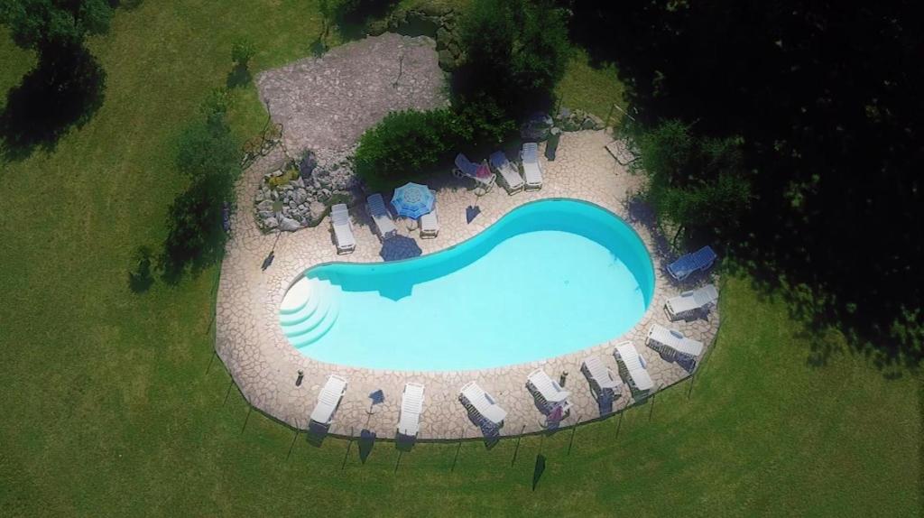 an aerial view of a swimming pool with chairs around it at Agriturismo La Grotta Di Montecchino in Siena