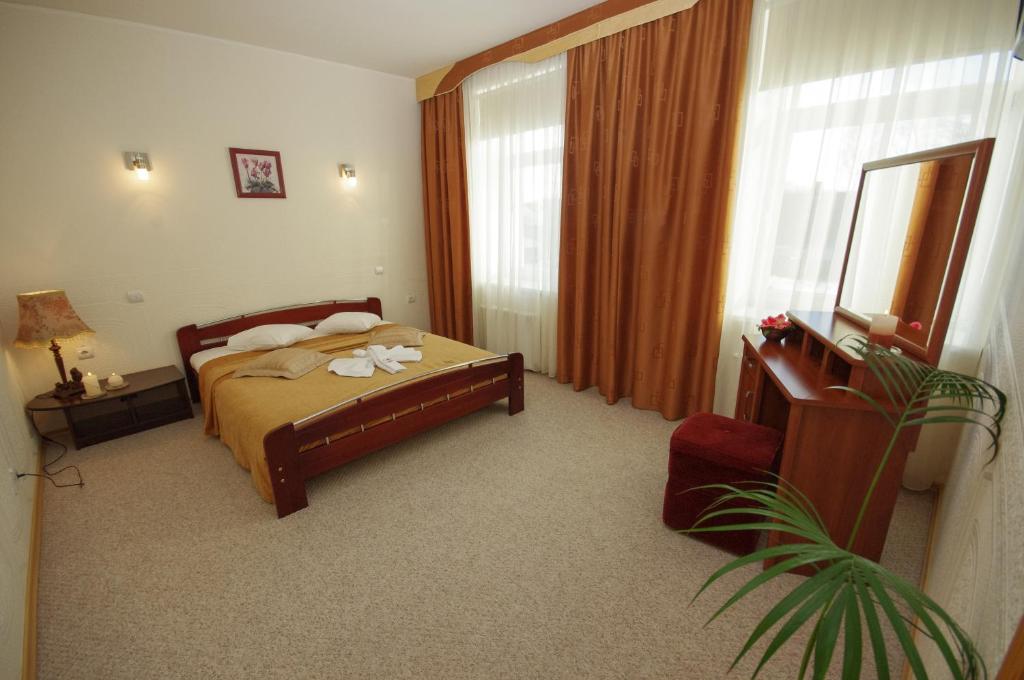Postel nebo postele na pokoji v ubytování Dinaburg SPA Hotel