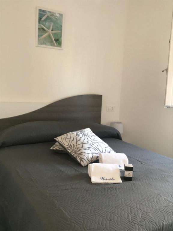 a bed with two towels and a pillow on it at Nereide in Tropea