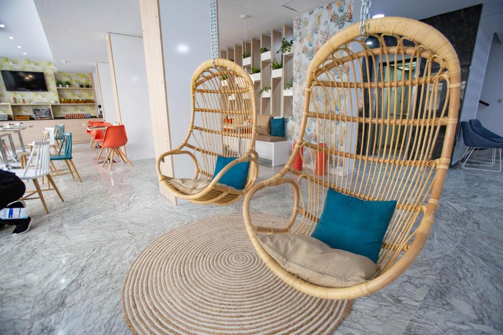 
a birdhouse with a bunch of chairs inside of it at Soho Bahía Málaga in Málaga
