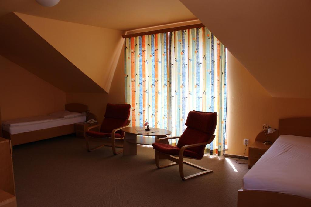 Postel nebo postele na pokoji v ubytování Motel U Krbu
