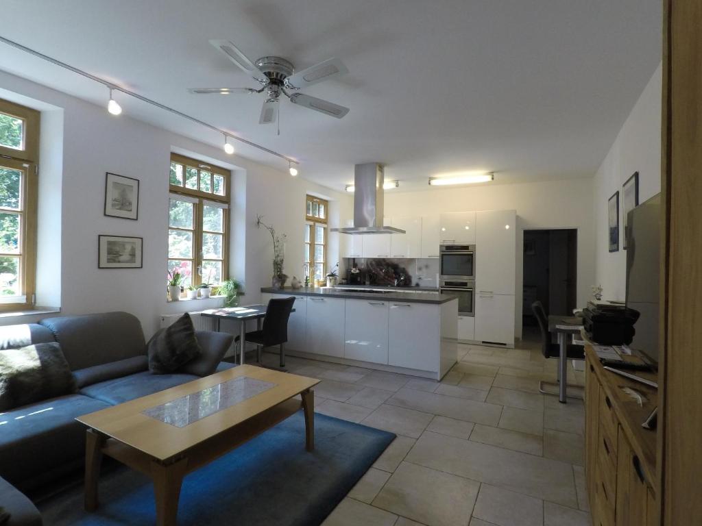 a living room with a couch and a table at Ferienwohnung auf dem Sturmhof in Grefrath