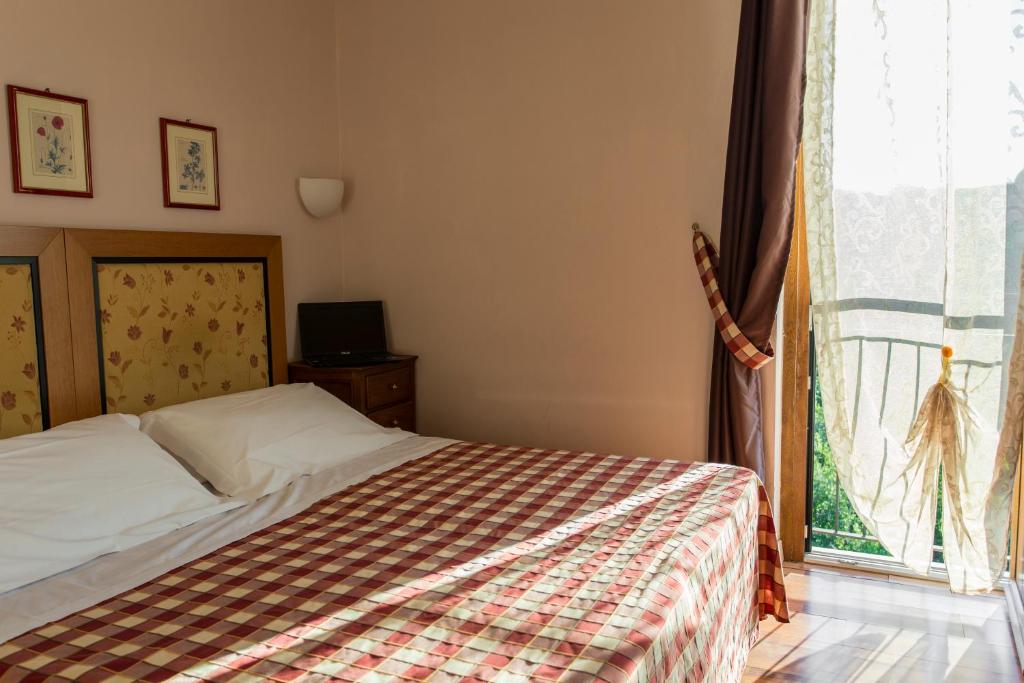 Posteľ alebo postele v izbe v ubytovaní Hotel Il Giardino