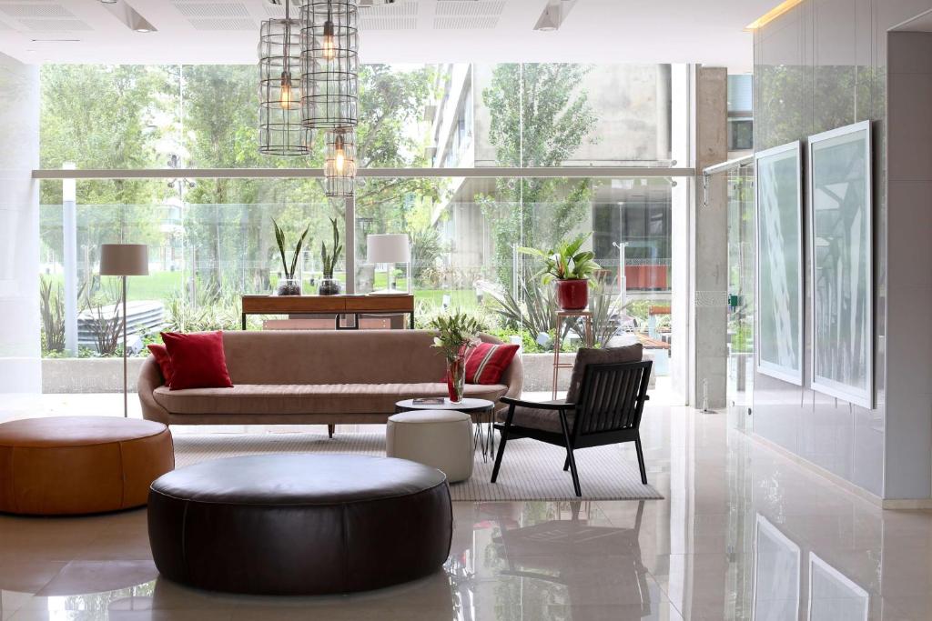 a large living room with a couch and chairs at Dazzler by Wyndham Rosario in Rosario