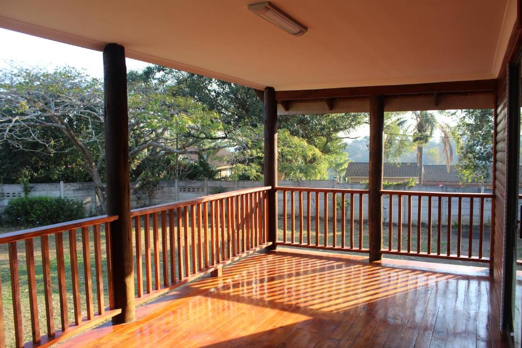 a screened porch with a view of the trees at Laudin's View in Umtentweni