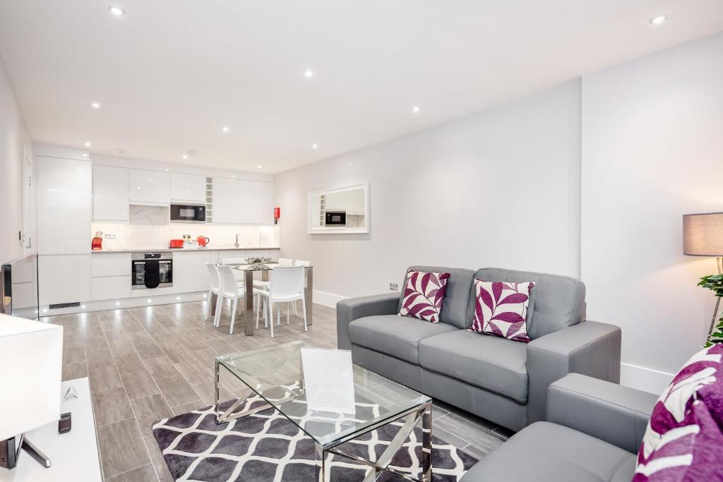 a living room with a couch and a table at Roomspace Serviced Apartments - The Legacy in Brighton & Hove