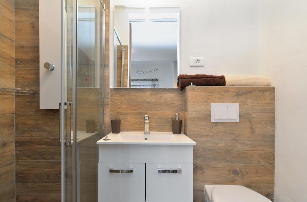 a bathroom with a white sink and a shower at Apartment Mirella 1745 in Bale