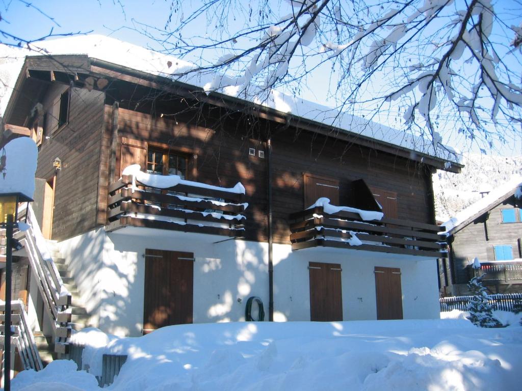 ein Haus mit Schnee auf dem Boden davor in der Unterkunft Mischi in Blatten bei Naters