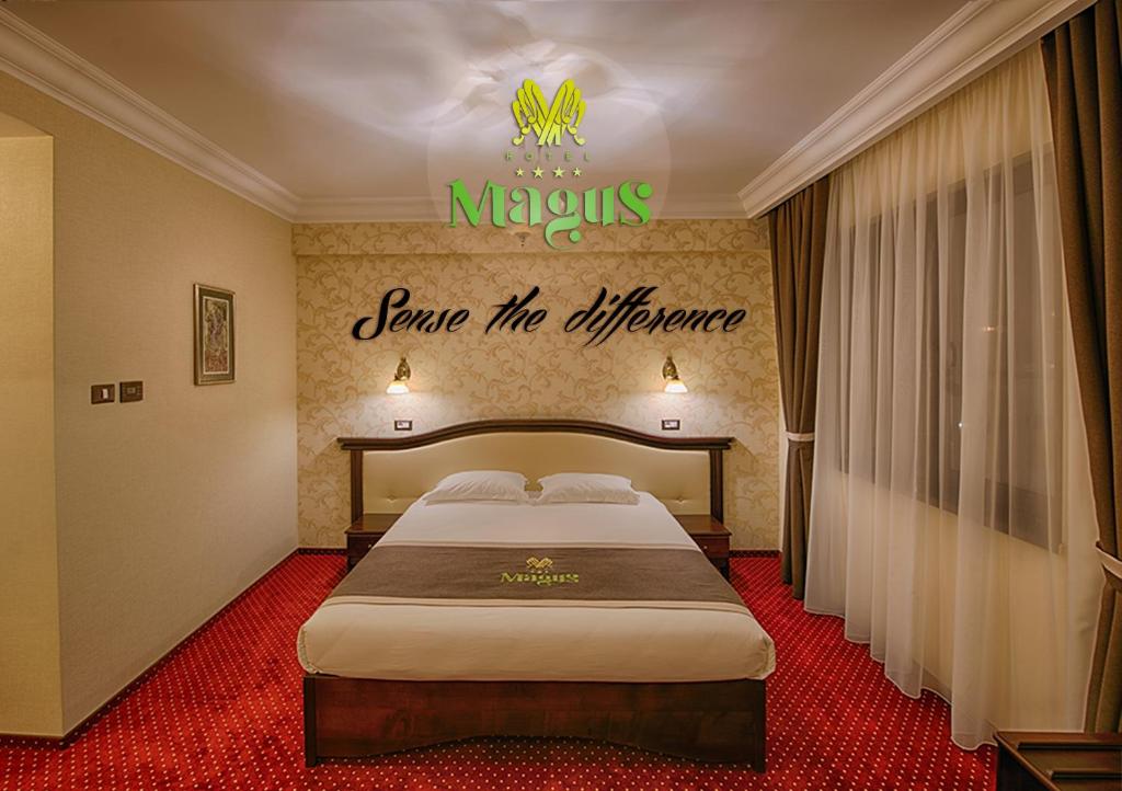 a hotel room with a bed with a sign on the wall at Magus Hotel in Baia Mare