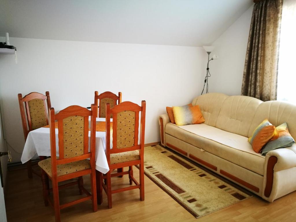 a living room with a couch and two chairs at Apartment Manda in Rakovica
