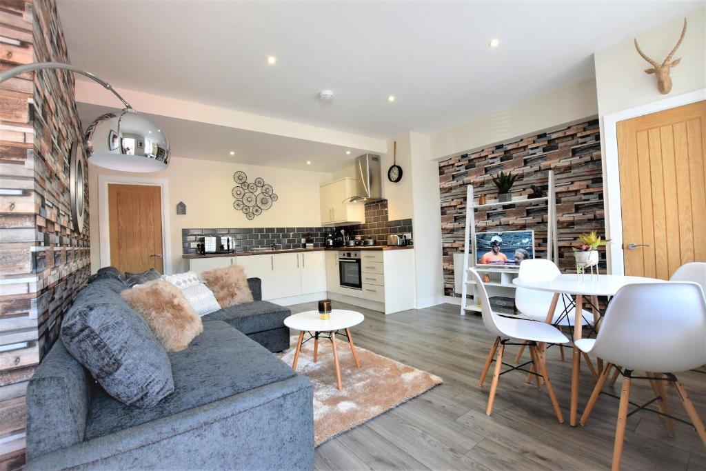 a living room and kitchen with a couch and a table at The Old Bank - Your Apartment in Bristol