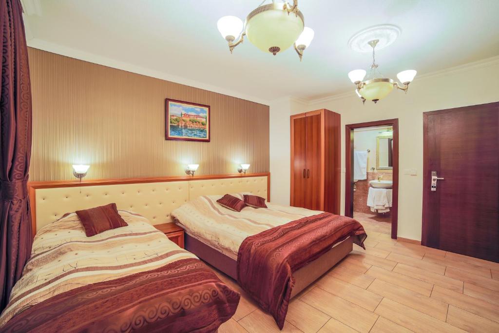 a hotel room with two beds and a mirror at Apartments Risteski in Ljubaništa