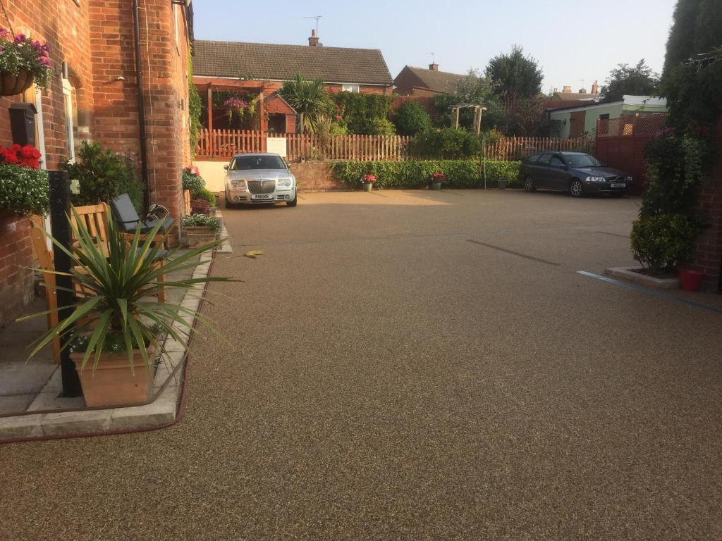 a parking lot with a car parked in a driveway at The Post House in Ibstock