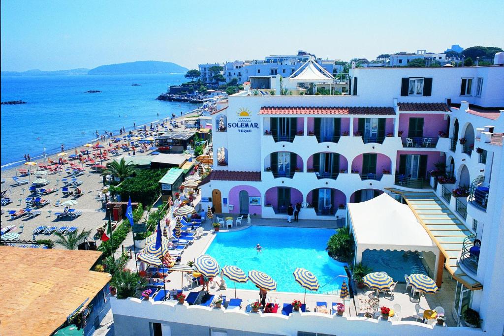 an aerial view of a resort with a swimming pool and a beach at Hotel Solemar Beach & Beauty SPA in Ischia