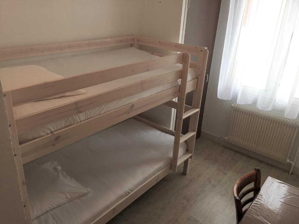 a wooden bunk bed in a room at Auberge Les Mufliers - Hôtel Les Forges in Pontenx-les-Forges