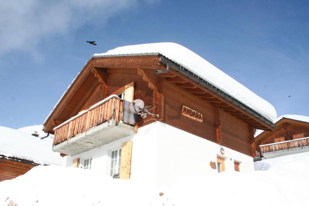 a house covered in snow with a balcony at Andara in Belalp