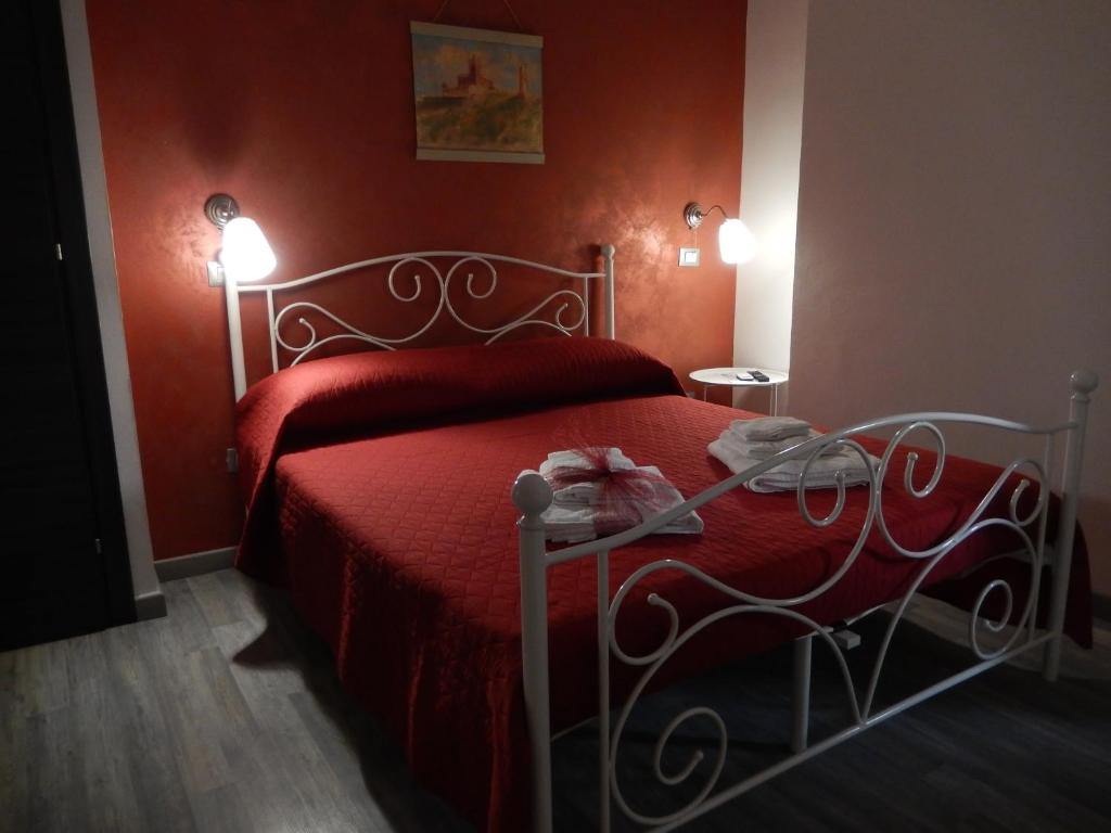 a red bedroom with a bed with a red bedspread at B&B Magna Graecia in Scalea