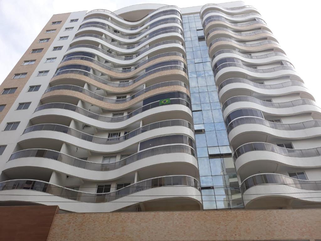a tall building with a lot of windows at Apartamento Residencial Julia in Guarapari