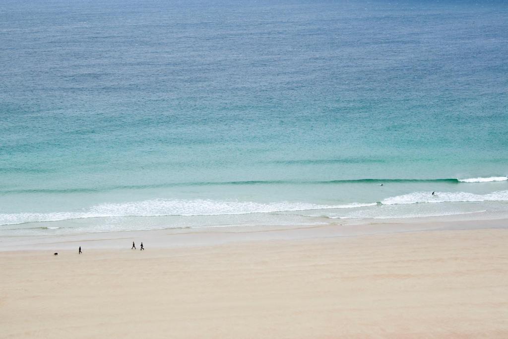 a group of people walking on the beach at Durness Youth Hostel in Durness