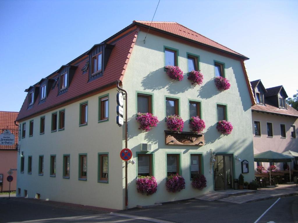 a white building with flowers on the side of it at Zenntaler Hof in Neuhof an der Zenn