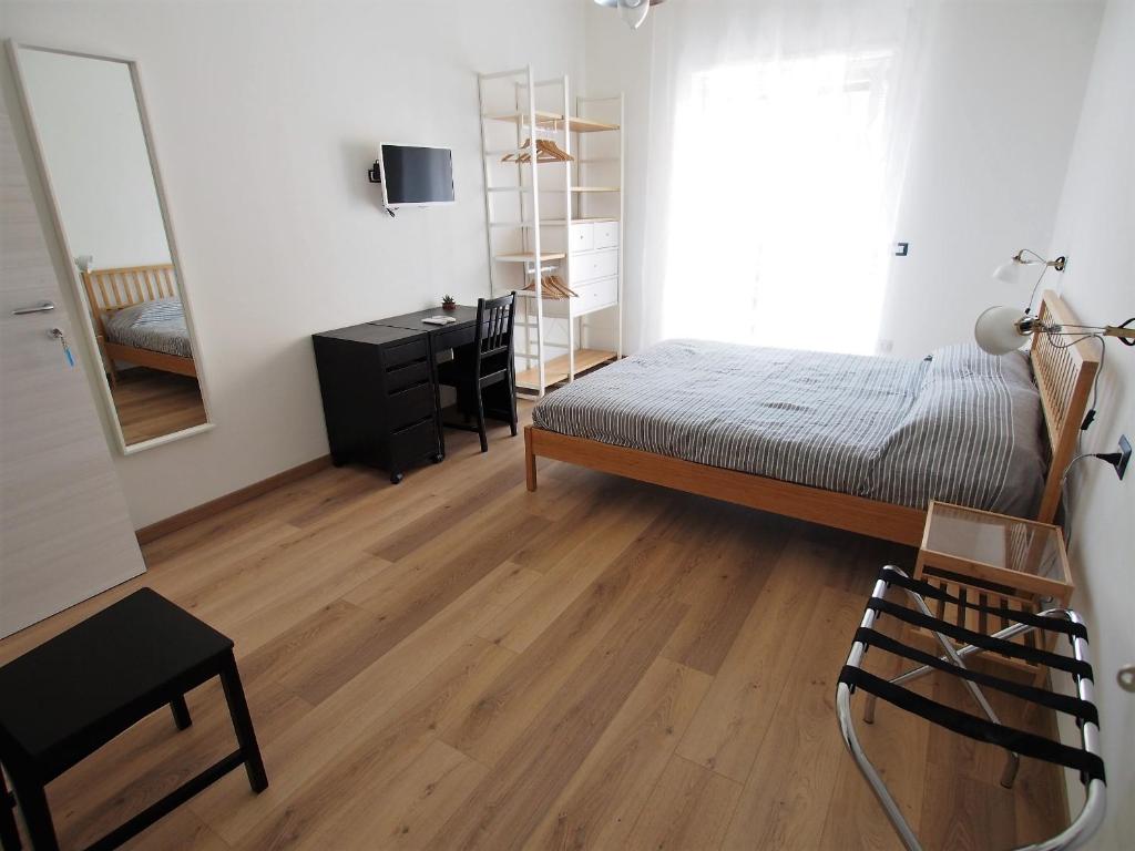 A bed or beds in a room at Bella Vita Rooms