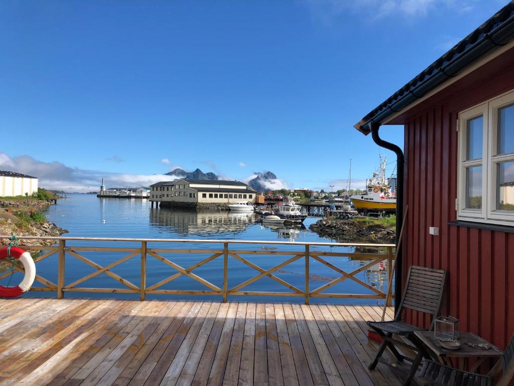 a deck with a view of a body of water at Nora's Waterfront Cabin in Svolvær