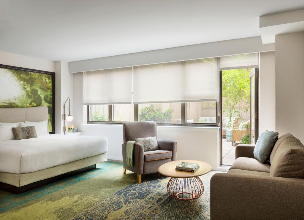 a living room filled with furniture and a window at The Gardens Sonesta ES Suites New York in New York
