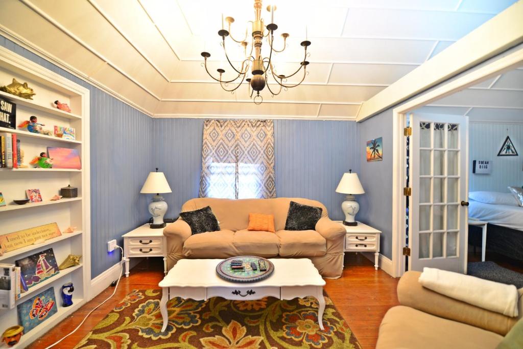 a living room with a couch and a table at Historic Apartment in the Heart of Christiansted in Christiansted