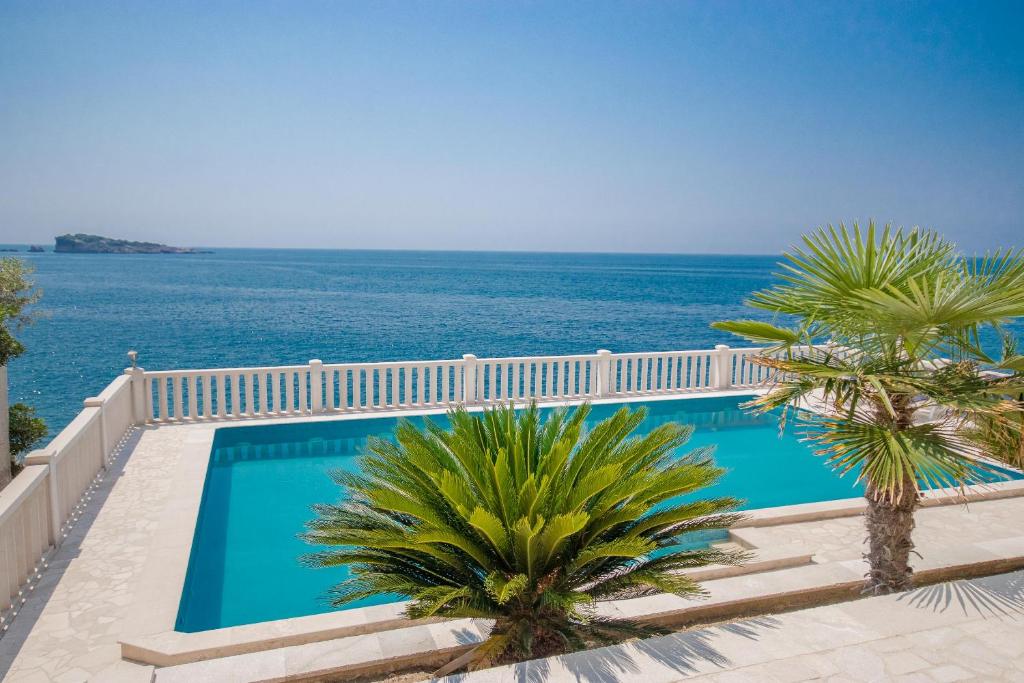 a swimming pool with a view of the ocean at Luxury penthouse Alena in Utjeha