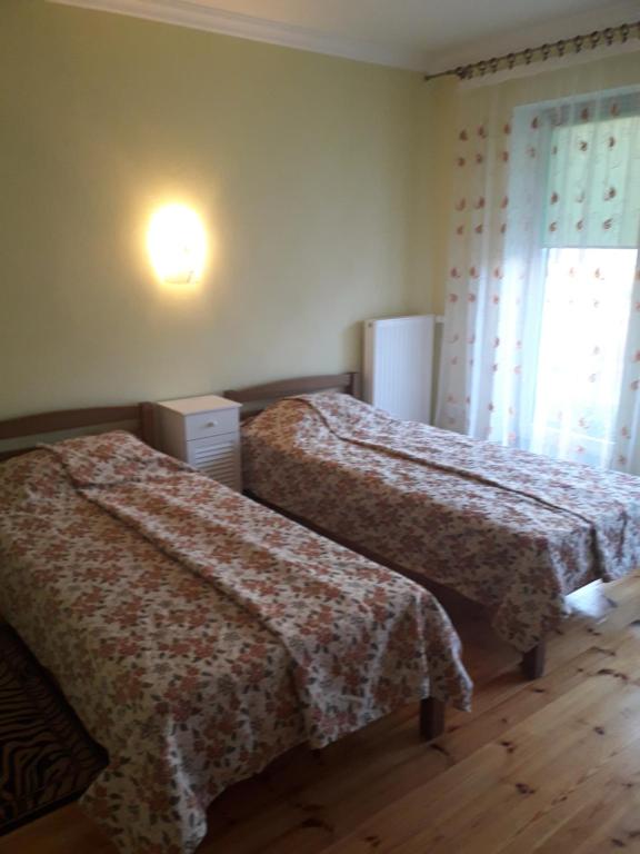a bedroom with two beds and a window at Apartments Natalija in Sigulda