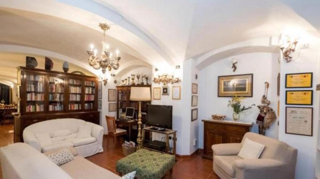 a living room with a couch and chairs and a tv at Hotel Residence La Contessina in Florence