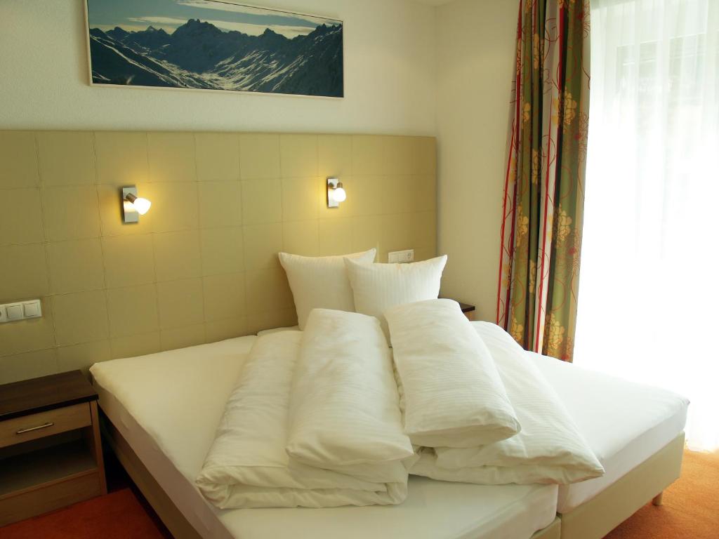 Postel nebo postele na pokoji v ubytování alpinea Appartements