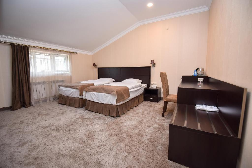 Postel nebo postele na pokoji v ubytování Laguna Hotel